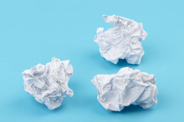 istock A piece of crumpled white paper on a blue background. 1409688880