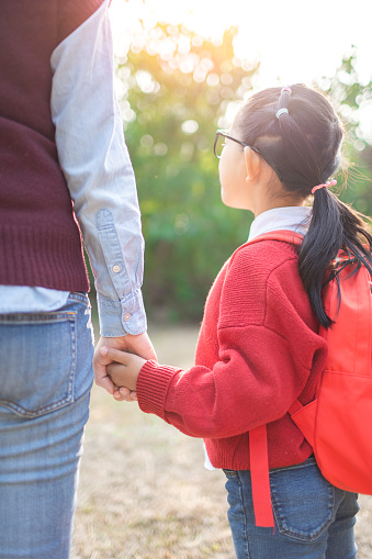 Daughter and mother's holding hands