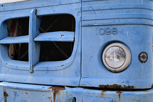 Gijón, Spain, June 25, 2022 : Grille of an old blue truck close-up