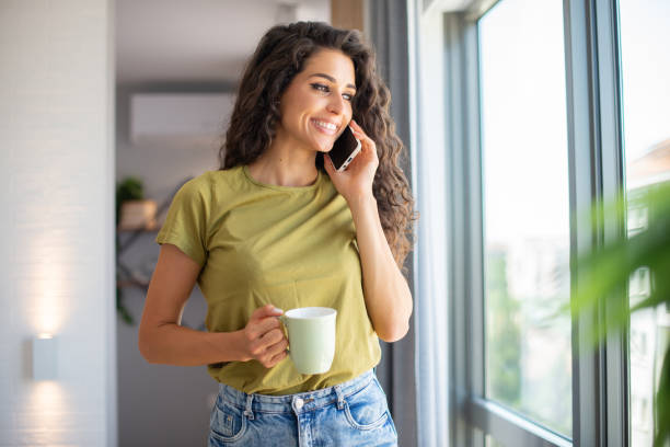 istock Happy young woman using phone 1409696962