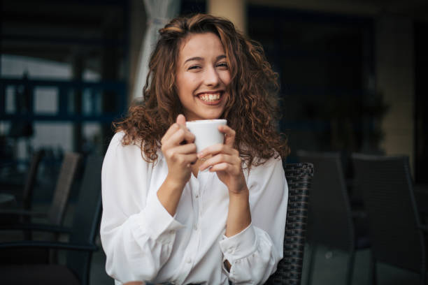 istock woman enjoying cappuccino in a cafe 1409699192