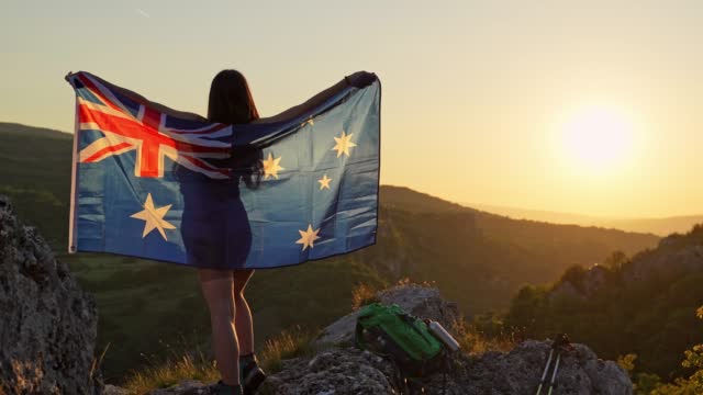 Waving An Australian Flag On The Top Of The Mountain