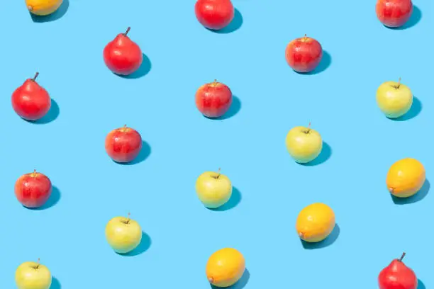 Summer pattern of ripe fruits on blue background. Minimal summer concept.