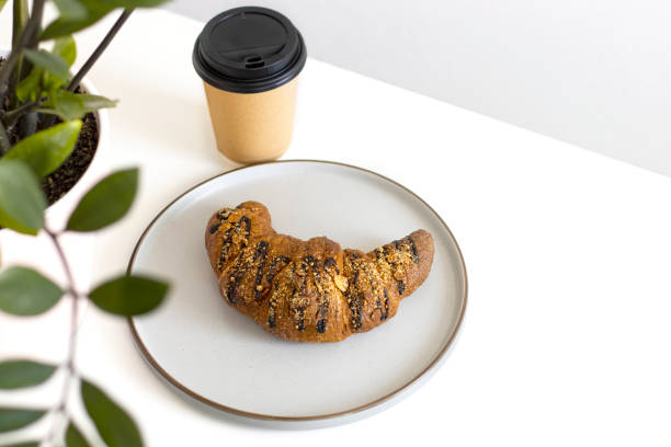 istock chocolate croissant on plate with and coffee. Concept Intuitive eating, breakfast, copyspace 1409702181