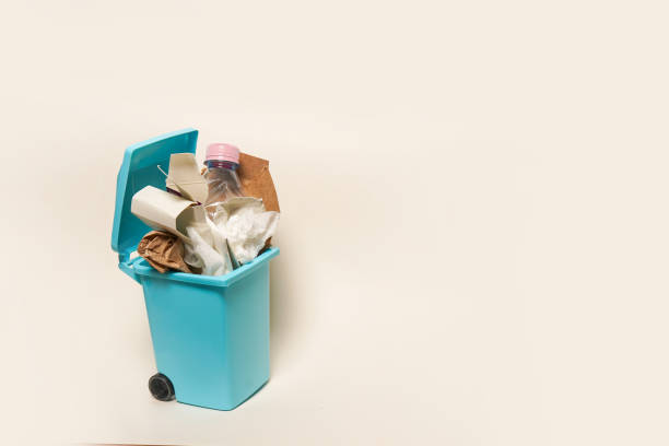 istock Over full paper trash can on white background with copy space 1409704253