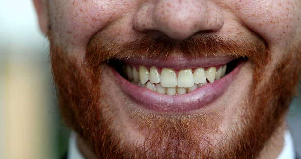 Close-up man mouth smiling. Redhead ginger person smile face closeup stock photo