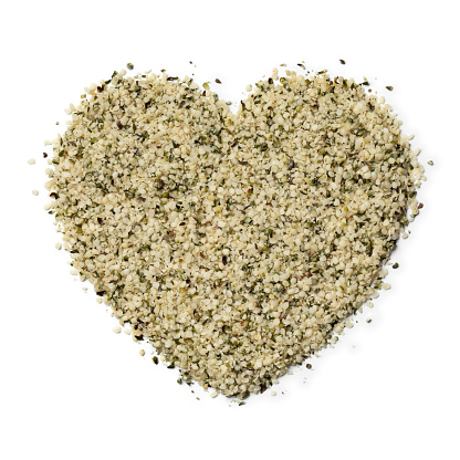 Hemp seed in heart shape isolated on white background