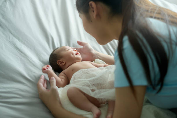 Young mother with a Cute new born baby.