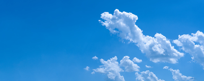 Blue sky background with cumulus clouds. Panorama. copy space