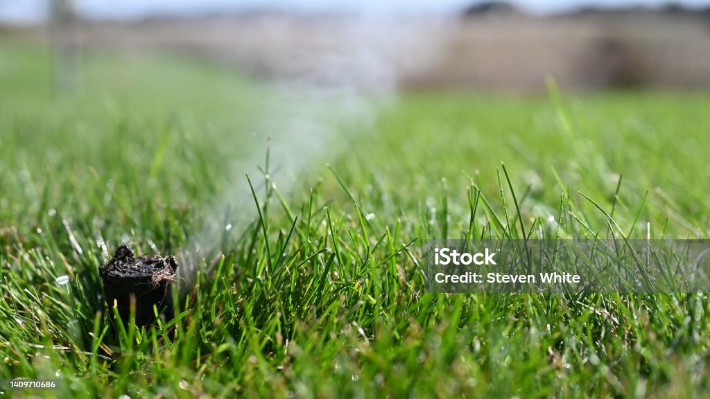 winterizing a irrigation sprinkler system by blowing pressurized air through to clear out water winterizing a irrigation sprinkler system by blowing pressurized air through to clear out water. High quality 4k footage Sprinkler Stock Photo