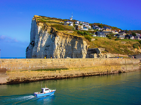 Boat in port and cliffs of Fécamp, Normandy, France