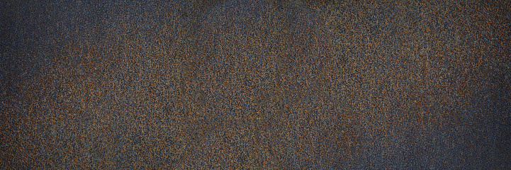 Rust texture. Rough rusty metal surface. Black Brown. Dark grunge background with space for design. Close-up. Web banner. Wide. Panoramic.