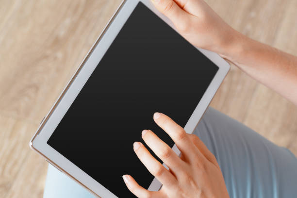 istock woman holding digital tablet, closeup 1409715576