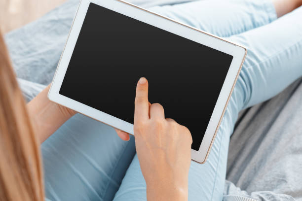 istock woman holding digital tablet, closeup 1409717638