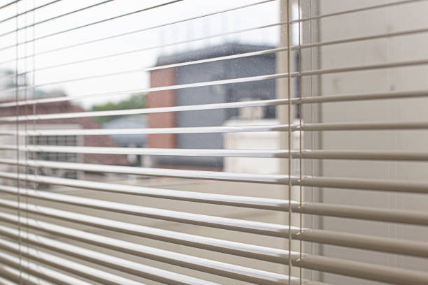 Window with open modern horizontal blinds indoors stock photo