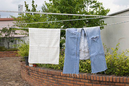 Towels and jeans hanging on the clothesline