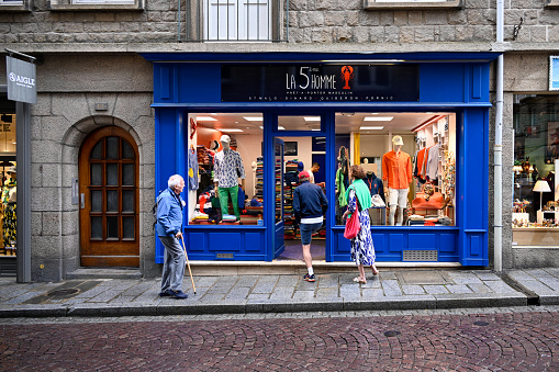 Saint-Malo, France, June 27, 2022 - People infront of the Men's outlet \