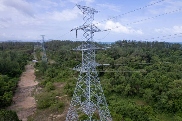 istock Aerial view high voltage steel power pylons Transmission tower supporting high voltage power line Tower of power lines in the forest. Electric tower line in Landscape nature view 1409722973