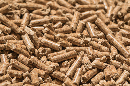 Wood pellets background, pattern. Pellets of natural wood close up. Ecological heating, energies renewable Biofuels