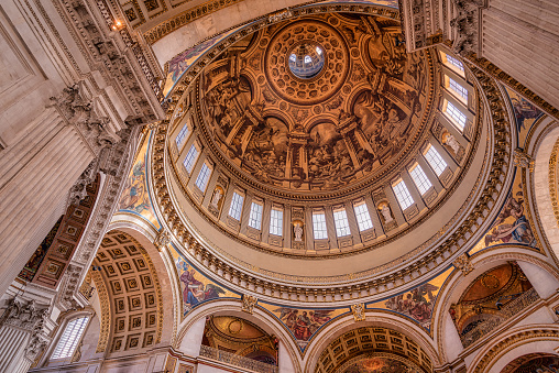 Interior shot of the paintings covered cupola of the monumental St. Paul's Cathedral in London, United Kingdom.