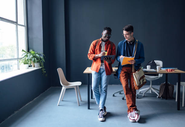 istock Two Happy Friends Talking In The Library 1409723984