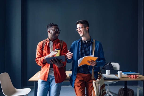 istock Two Happy Friends Talking In The Library 1409723988