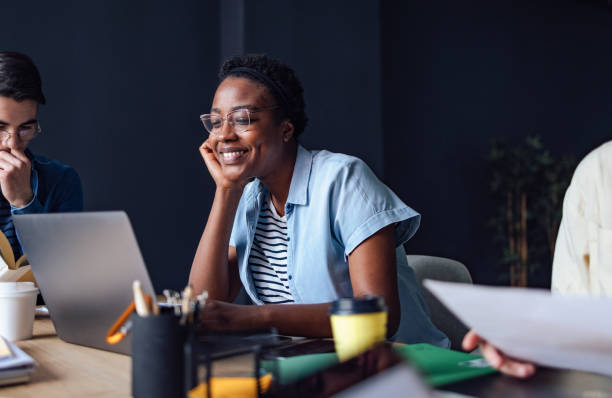 istock Young Woman Studying In The Library With Friends 1409724015
