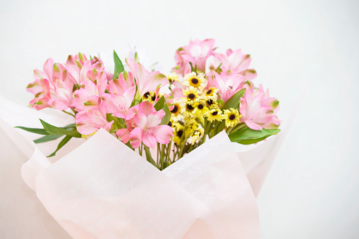 Bouquet of flowers with pink lilies and yellow chrysanthemums. Flowers for delivery.