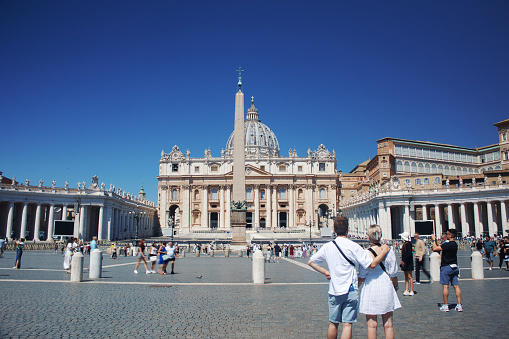 13th June, 2022: Tourists taking in the magnificent view of St. Peter's Basilica in Vatican City, Rome, Italy on a beautiful clear blue sky day.