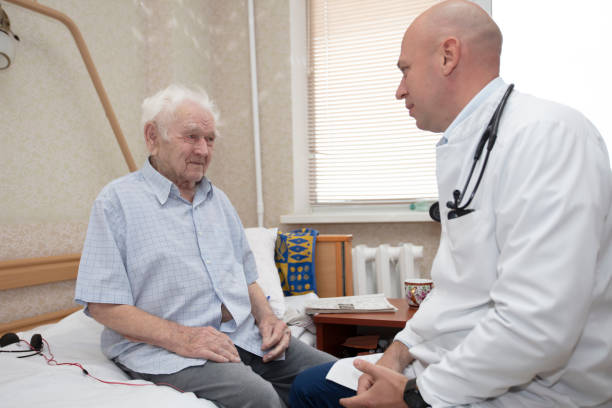 istock The therapist talks with an elderly patient. A caring cardiologist is talking to an old man. 1409725082