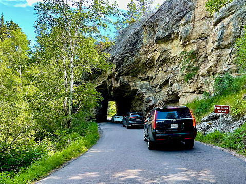 Custer, South Dakota - July 4, 2022: Tourists wait to drive through the Iron Creek Tunnel on the popular Needles Highway within Custer State Park on Independence Day.