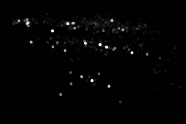 istock White gray blurred bokeh lights on black background 1409726920