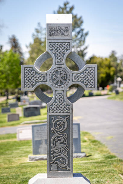 istock Celtic Stone Religious Cross-shaped Headstone at a Cemetery at Day 1409726983