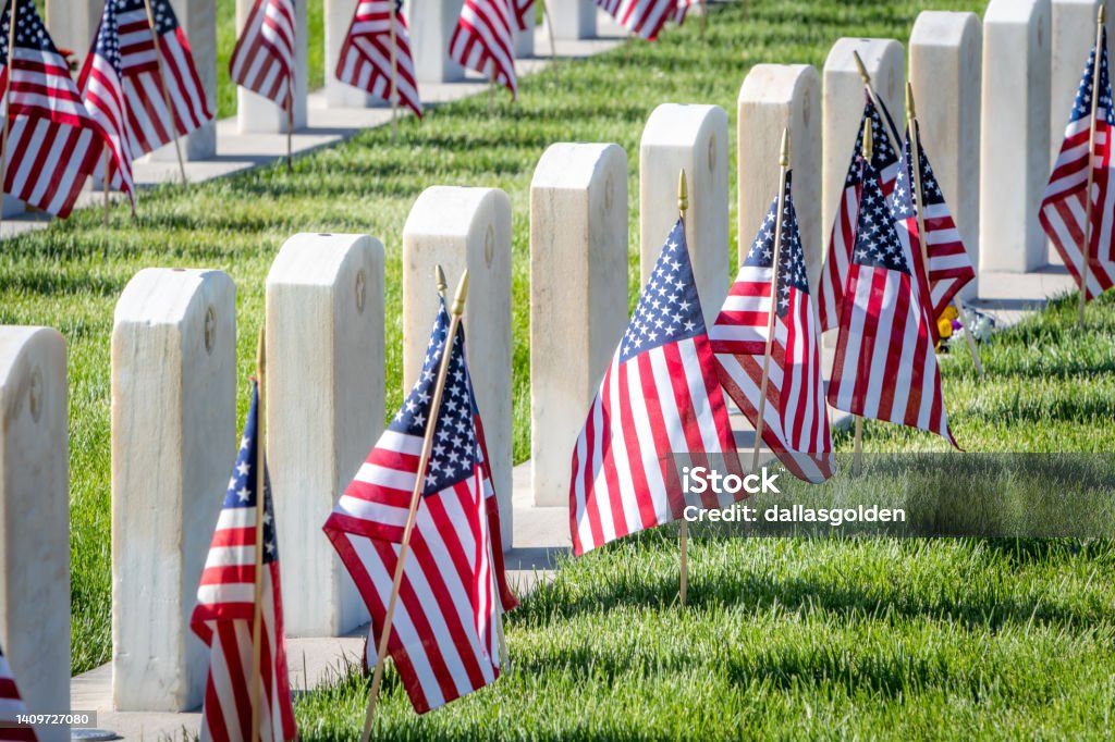 Military Headstones and Gravestones Decorated With Flags for Memorial Day Military headstones honoring armed forces servicemen decorated with American flags for Memorial Day US Memorial Day Stock Photo