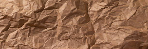 Crumpled craft paper texture background banner Brown crumpled, wrinkled recycle craft paper texture background banner. Wide panoramic header narrow photos stock pictures, royalty-free photos & images