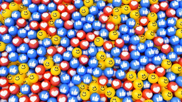Photo of Social media icon background. Multicolor balls with smile face, heart and thumbs up symbols.