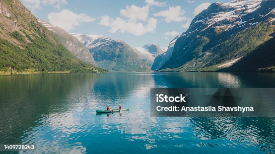 istock Aerial view of woman and man contemplating summer in Norway canoeing in the lake Lovatnet 1409728243