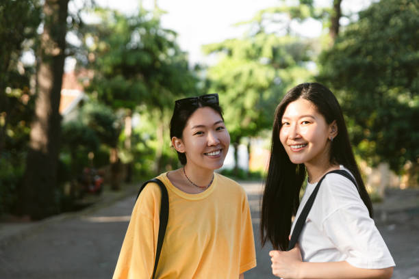 istock Smiling young women in park 1409729516