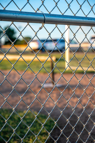 istock Focus on chain link fence with t-ball background 1409729675