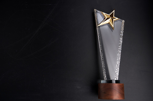 crystal star trophy against blackboard