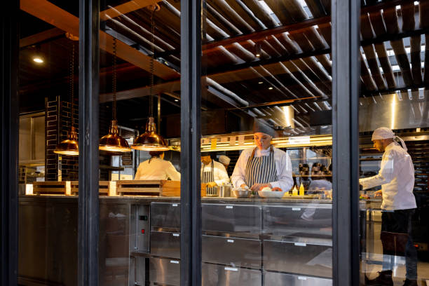 istock Group of cooks working in a commercial kitchen at a restaurant 1409730002