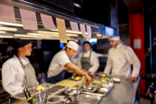 Close-up on order tickets at a commercial kitchen - food and drink establishment concepts