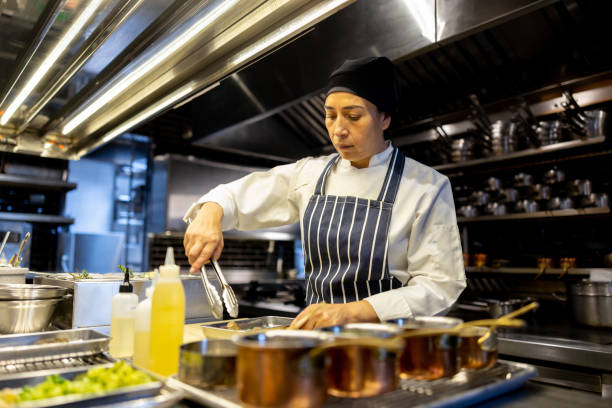 istock Cook preparing food in a commercial kitchen at a restaurant 1409730009