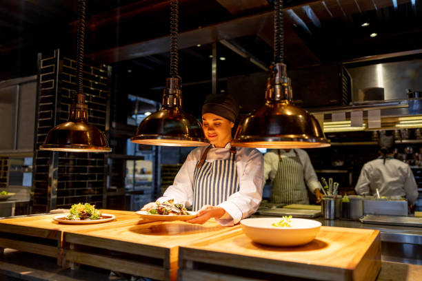 istock Happy chef getting a plate ready for service at a restaurant 1409730036