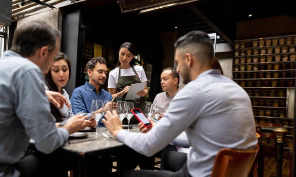 istock Man at a restaurant asking a question to the waitress about the menu 1409730569