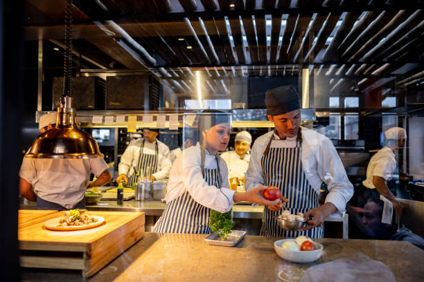 istock Cooks working at a restaurant and preparing food in the kitchen 1409730580