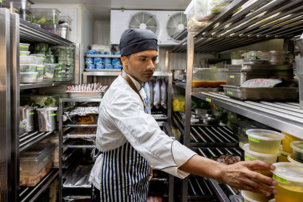 istock Chef looking for some ingredients in the pantry at a commercial kitchen 1409730592