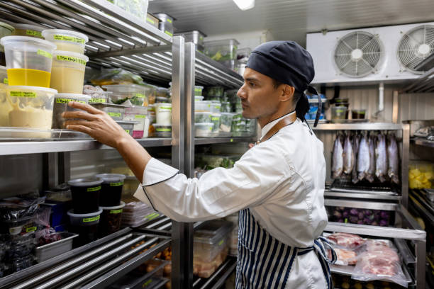 Chef working at a restaurant and looking for some ingredients in the pantry