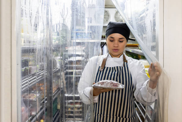 istock Chef working at a restaurant and grabbing some ingredients from the fridge 1409730626