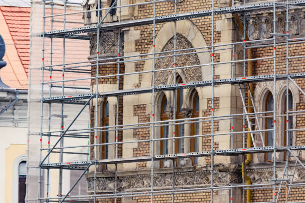 Old building restoration Restoration of an old european historic building with scaffolding next to it historic building photos stock pictures, royalty-free photos & images